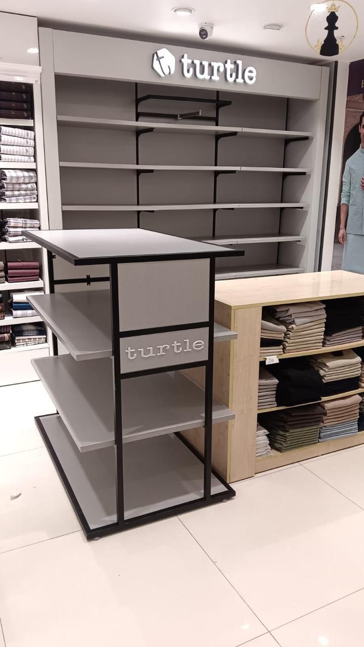 Turtle retail store fixtures, wall systems and display tables by Avinya Furnitures